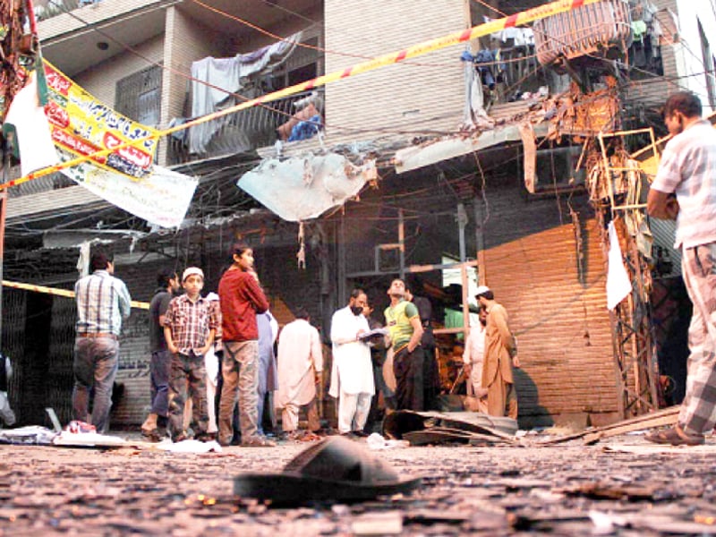 shattered glass litters the street next to the shop that was targeted by extortionists on thursday night photo online