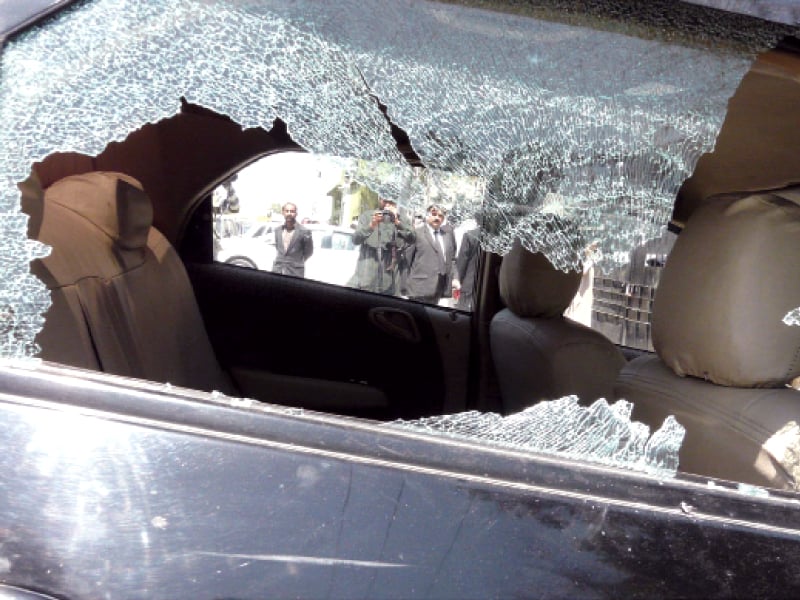 the bullet riddle car with shattered glass windows photo inp