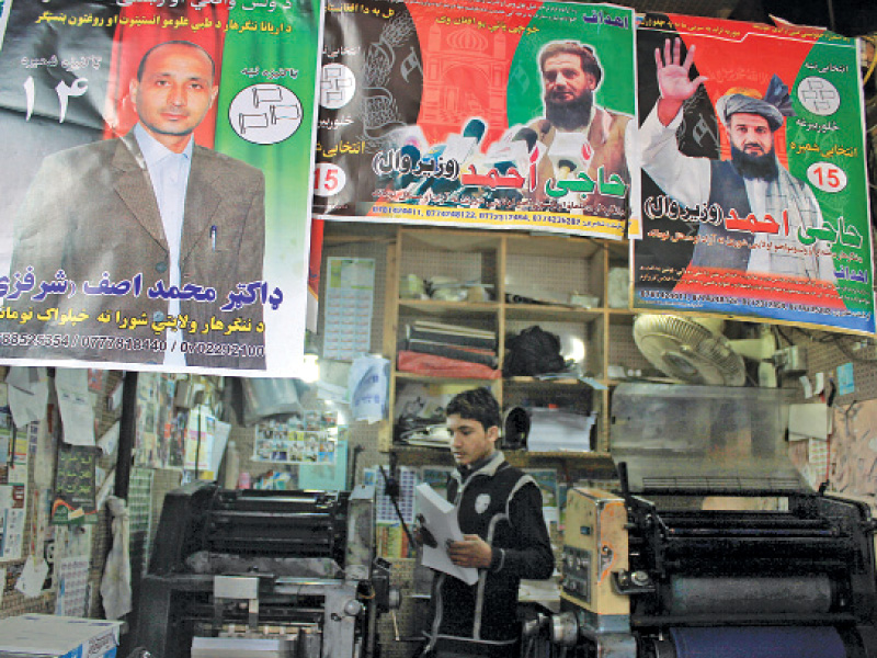 posters of afghan presidential candidates cover shop fronts in mohallah jangi photo muhammad iqbal express