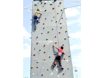going up future mountaineers test skills at wall climbing competition