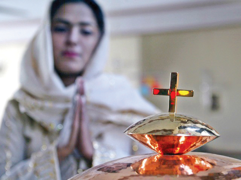 a member of the christian community prays during a ceremony at a church in peshawar photo file