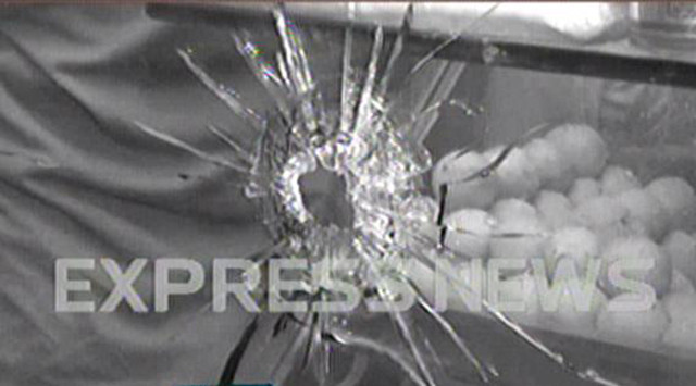 a screen shot showing a bullet hole in the glass of the sweet shop a screen shot showing a bullet hole in the glass of the sweet shop
