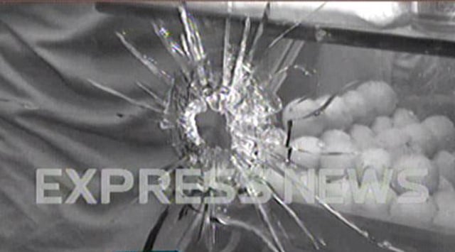 a screen shot showing a bullet hole in the glass of the sweet shop