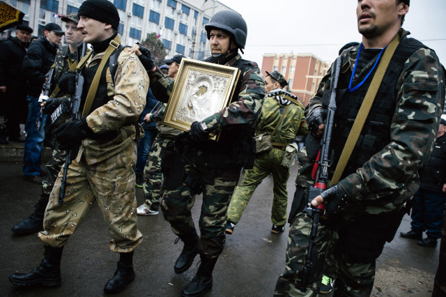 armed pro russian supporters carry an eastern orthodox icon of mary magdalene outside the secret service building in the eastern ukrainian city of lugansk on april 13 2014 photo afp armed pro russian supporters carry an eastern orthodox icon of mary magdalene outside the secret service building in the eastern ukrainian city of lugansk on april 13 2014 photo afp
