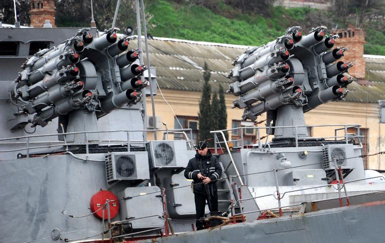 a sailor guards a russian navy ship in the bay of sevastopol on march 9 2014 photo afp