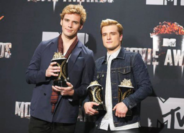 actors sam claflin and josh hutcherson pose backstage with their award for best movie of the year and best male performance respectively photo file actors sam claflin and josh hutcherson pose backstage with their award for best movie of the year and best male performance respectively photo file