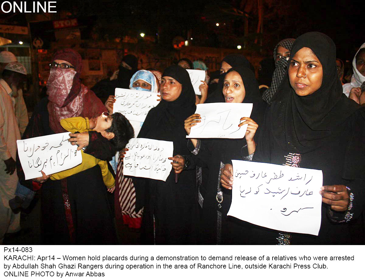 women hold up names of their relatives who were detained by rangers during an operation in ranchore line hrcp says 44 people were killed by paramilitary soldiers netweem january and march photo online