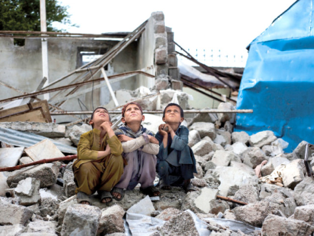 three students of pehli kiran sit atop the remains of what used to be their school photo myra iqbal express three students of pehli kiran sit atop the remains of what used to be their school photo myra iqbal express