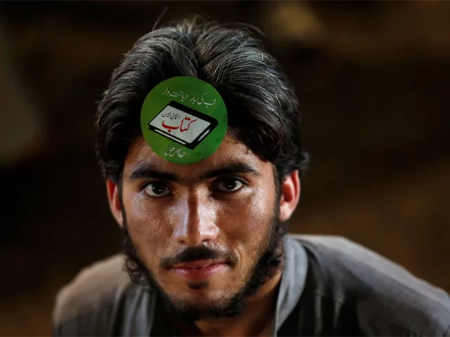 a supporter of the muttahida majlis e amal mma adorns an electoral sticker during a campaign rally ahead of general elections in karachi pakistan july 15 2018 photo reuters a supporter of the muttahida majlis e amal mma adorns an electoral sticker during a campaign rally ahead of general elections in karachi pakistan july 15 2018 photo reuters