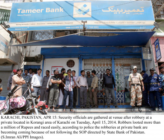 police rangers and security personnel stand guard outside the bank which was robbed in korangi on tuesday photo ppi police rangers and security personnel stand guard outside the bank which was robbed in korangi on tuesday photo ppi