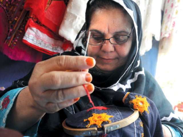 shahida bibi hard at work while keeping an eye out for customers photo express shahida bibi hard at work while keeping an eye out for customers photo express