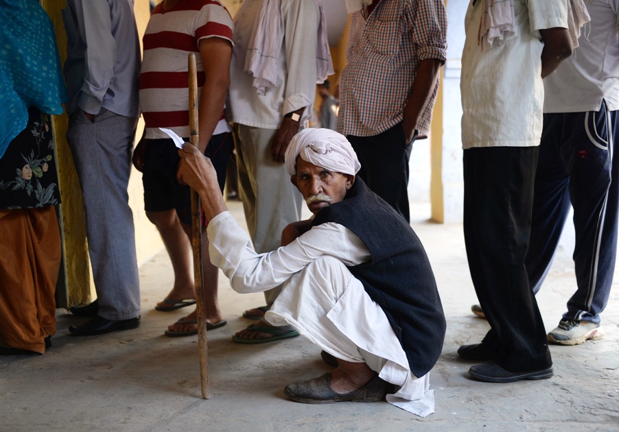 indian voter waits in line before he can cast his vote photo afp