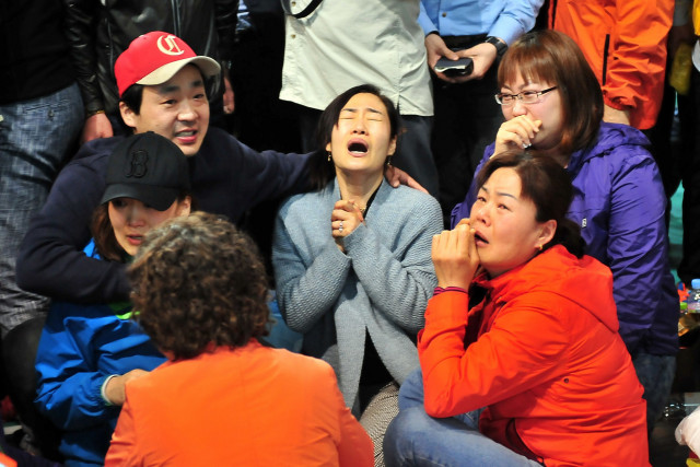 relatives of passengers on board a capsized ferry cry as they wait for news about their loved ones at a gym in jindo on april 17 2014 photo afp relatives of passengers on board a capsized ferry cry as they wait for news about their loved ones at a gym in jindo on april 17 2014 photo afp