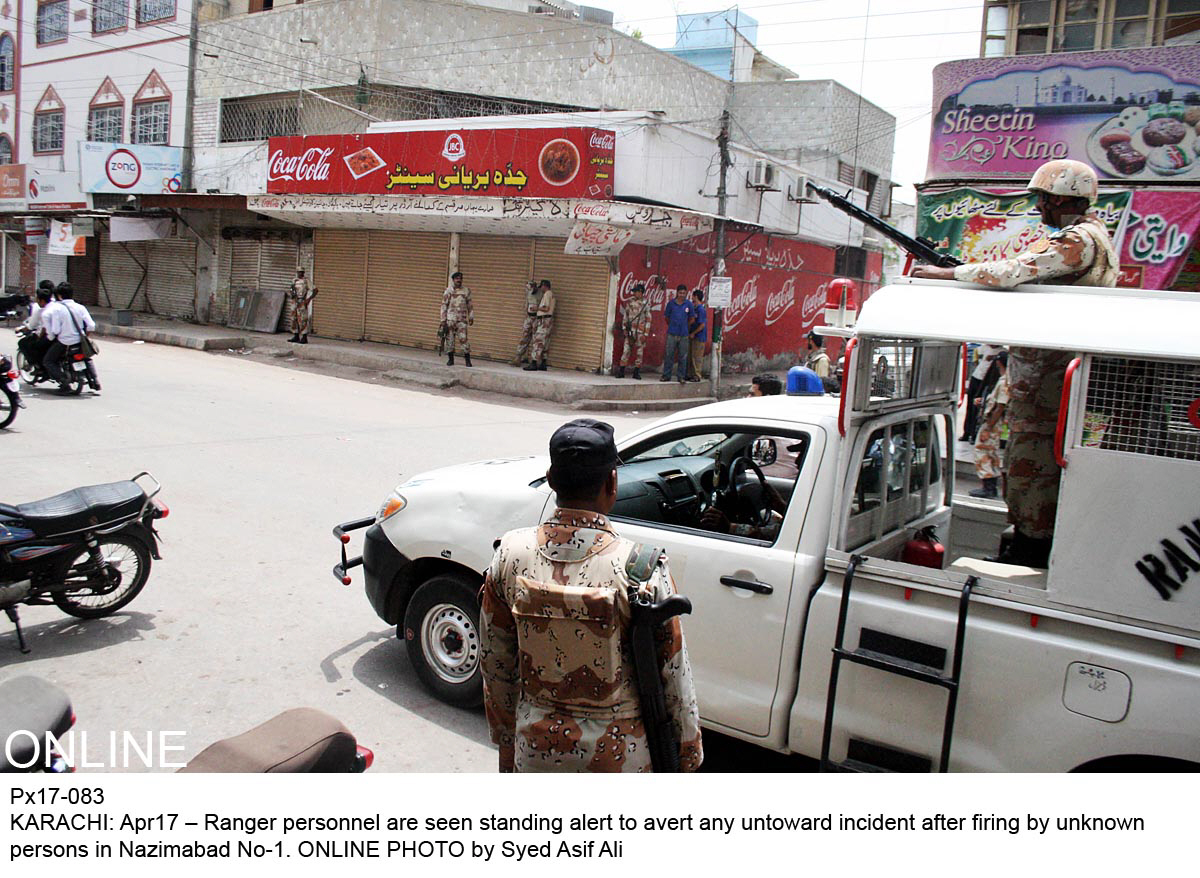 rangers officials stand guard with shops closed in nazimabad after firing by unknown men photo online