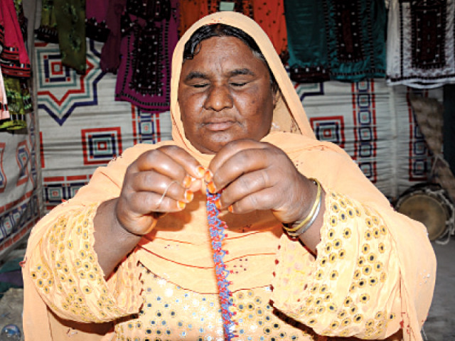 sehat creating a necklace with multi coloured beads photo express sehat creating a necklace with multi coloured beads photo express
