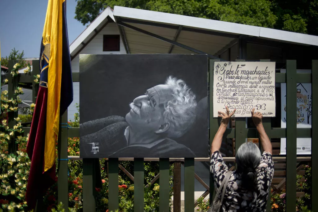 a woman places a banner next to a picture of late colombian 1982 literature nobel prize laureate gabriel garcia marquez outside the house in which he was born now turned into a museum in aractaca magdalena department in northern colombia on april 18 2014 photo afp a woman places a banner next to a picture of late colombian 1982 literature nobel prize laureate gabriel garcia marquez outside the house in which he was born now turned into a museum in aractaca magdalena department in northern colombia on april 18 2014 photo afp
