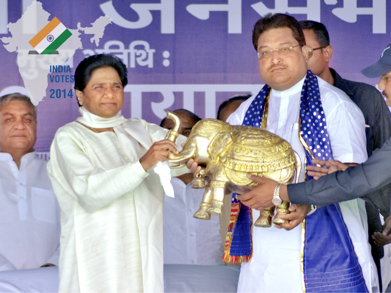mayawati chief of bahujan samaj party bsp receives a model of an elephant the bsp s electoral symbol presented to her by her party s candidate yogesh divedi during an election campaign rally in mathura photo reuters