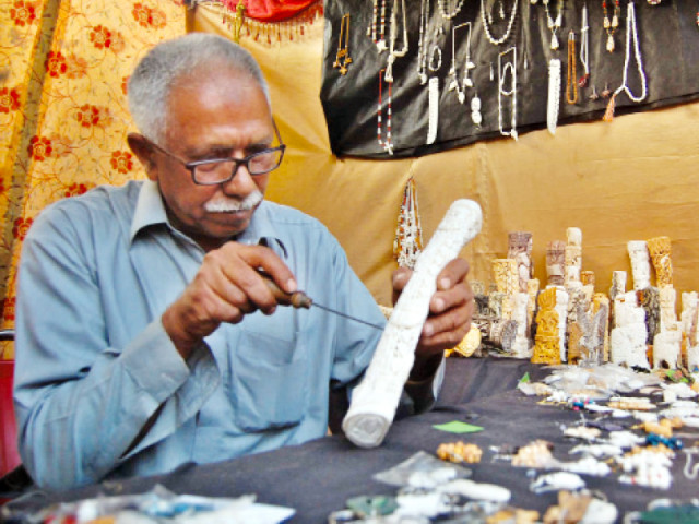 qureshi applying finishing touches to a decoration piece at his stall at lok mela photo muhammad javaid express qureshi applying finishing touches to a decoration piece at his stall at lok mela photo muhammad javaid express