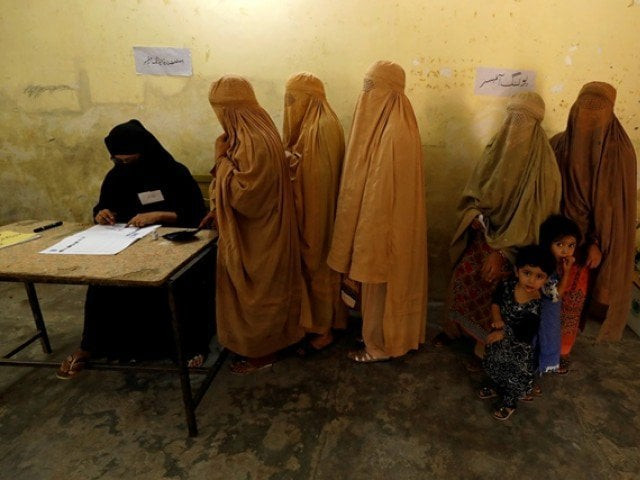 women clad in burqas stand in line to cast their ballot at a polling station during general election in peshawar photo reuters
