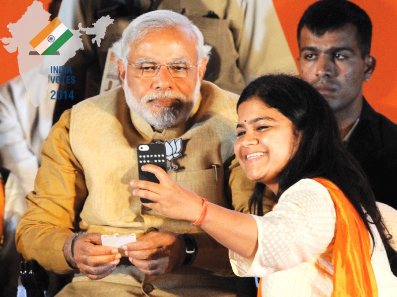 narendra modi poses for a photograph as party candidate from mumbai poonam mahajan takes a selfie with him at an election rally in mumbai photo afp