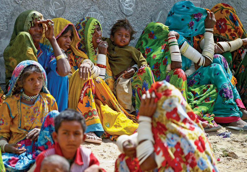 drought affected women wait for relief supplies at a state run distribution centre in mithi the main town in the tharparkar district photo file