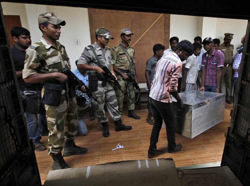 workers carry electronic voting machines evm in a trunk as indian security personnel stand guard at an election material distribution centre ahead of the sixth phase of the general election in the southern indian city of chennai photo reuters