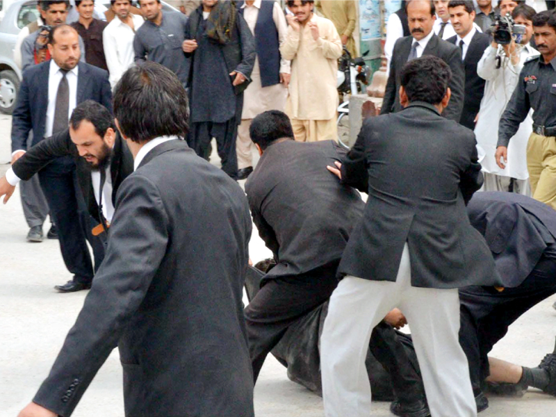 lawyers pound a security official at manan chowk in quetta on wednesday photo inp