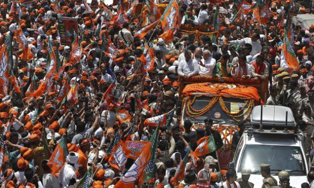 hindu nationalist narendra modi waves to his supporters as he arrives to file his nomination papers for the general elections in the northern indian city of varanasi photo reuters hindu nationalist narendra modi waves to his supporters as he arrives to file his nomination papers for the general elections in the northern indian city of varanasi photo reuters