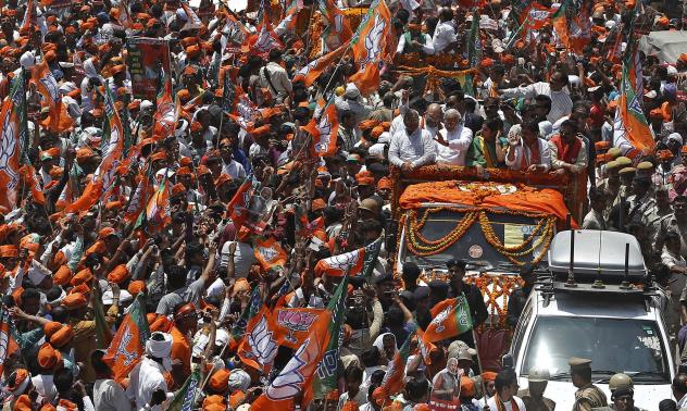 hindu nationalist narendra modi waves to his supporters as he arrives to file his nomination papers for the general elections in the northern indian city of varanasi photo reuters