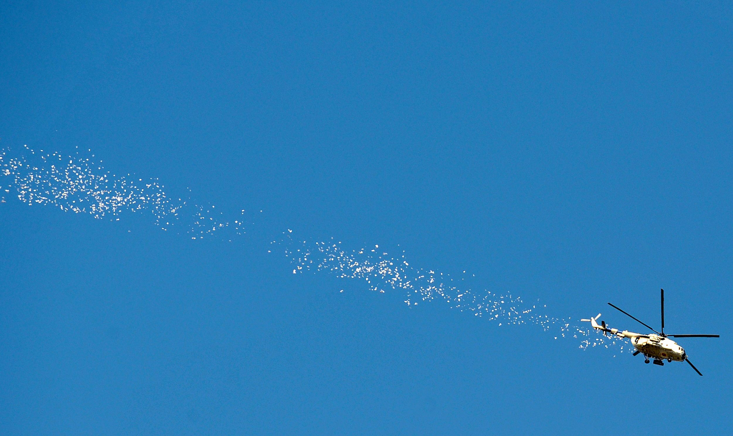 a ukrainian helicopter drops leaflets as it flies above the eastern ukrainian city of slavyansk on april 24 2014 up to five insurgents were killed when ukraine 039 s military today launched an assault on the flashpoint rebel held town of slavyansk sending in armoured vehicles and a helicopter afp journalists in the town reported photo afp
