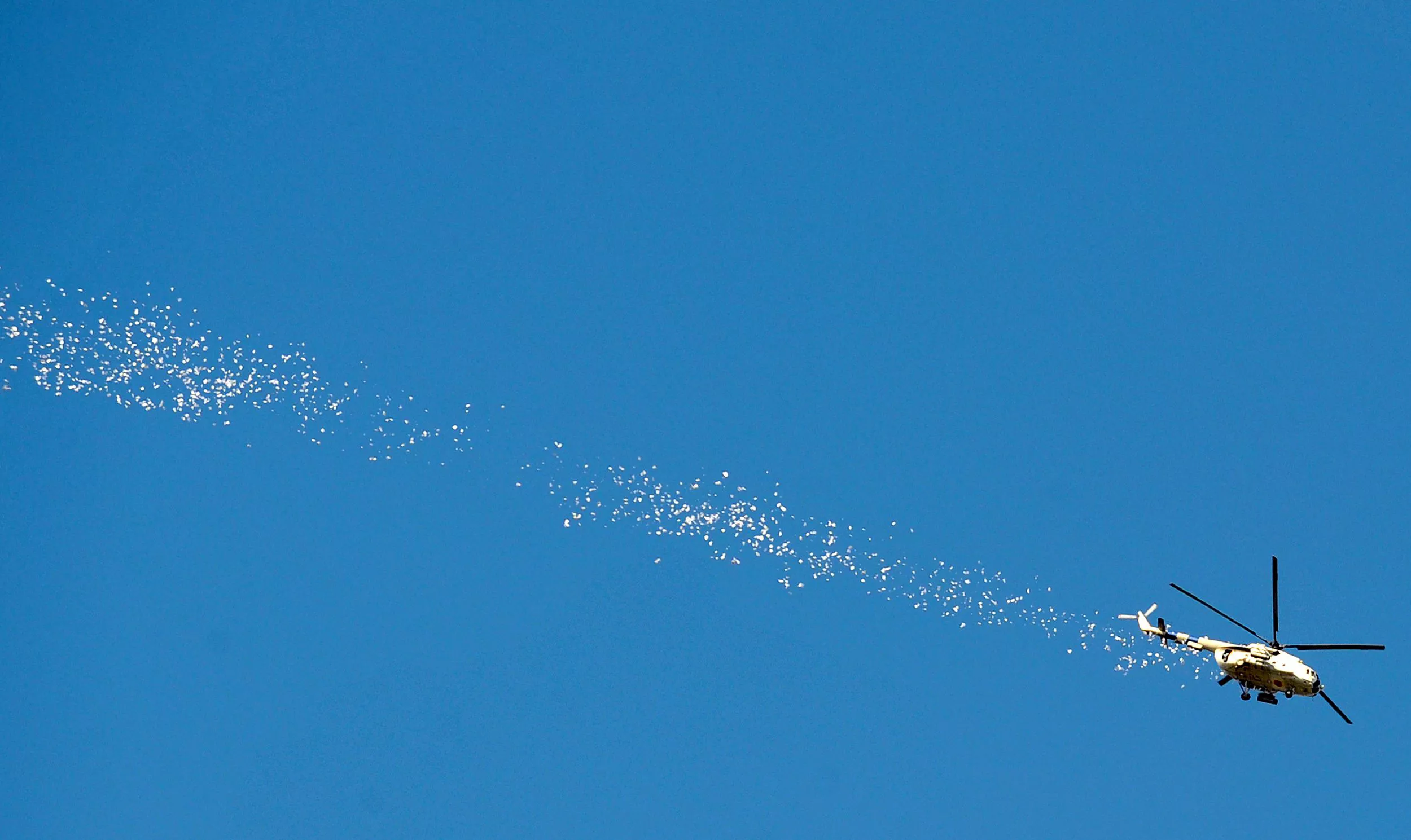 a ukrainian helicopter drops leaflets as it flies above the eastern ukrainian city of slavyansk on april 24 2014 up to five insurgents were killed when ukraine 039 s military today launched an assault on the flashpoint rebel held town of slavyansk sending in armoured vehicles and a helicopter afp journalists in the town reported photo afp a ukrainian helicopter drops leaflets as it flies above the eastern ukrainian city of slavyansk on april 24 2014 up to five insurgents were killed when ukraine 039 s military today launched an assault on the flashpoint rebel held town of slavyansk sending in armoured vehicles and a helicopter afp journalists in the town reported photo afp