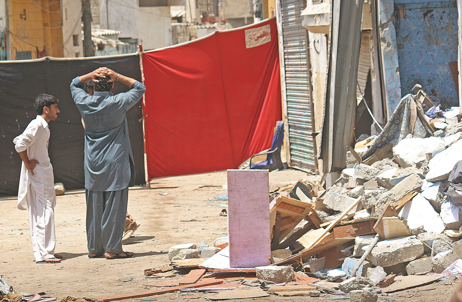 police inspector shafiq tanoli was sitting outside a tailor s shop near his house located close to old sabzi mandi when a powerful bomb blast took away his life most buildings in the vicinity also bore the brunt of the attack photos athar khan express