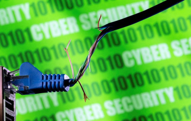 broken ethernet cable is seen in front of binary code and words cyber security in this illustration taken march 8 2022 photo reuters