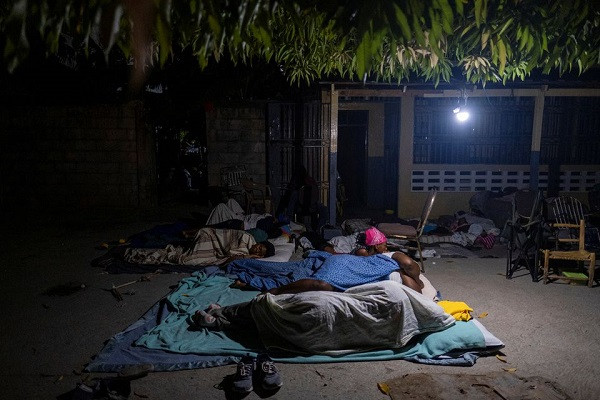 people rest outside their home after tremors shook buildings following saturday s 7 2 magnitude earthquake in les cayes haiti august 19 2021 photo reuters