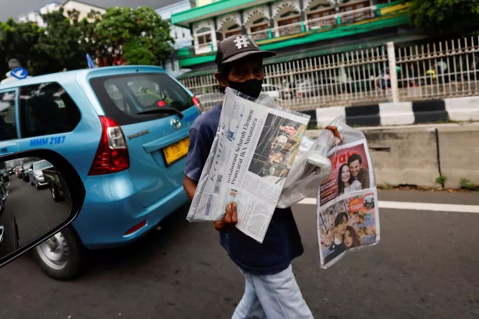 a street vendor sells papers with the news of indonesian new capital nusantara ikn on its headline during a traffic in jakarta march 15 2022 reuters willy kurniawan file photo a street vendor sells papers with the news of indonesian new capital nusantara ikn on its headline during a traffic in jakarta march 15 2022 reuters willy kurniawan file photo