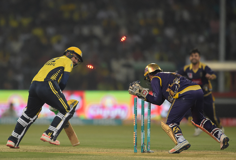 Sarfraz Ahmed (R) captain and wicketkeeper of Quetta Gladiators stumps out Peshawar Zalmi batsman Khusdil Shah. PHOTO: AFP