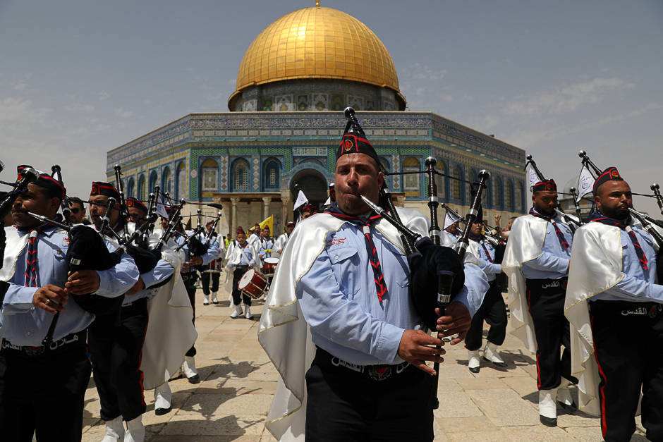 Palestinian scouts play music during the 