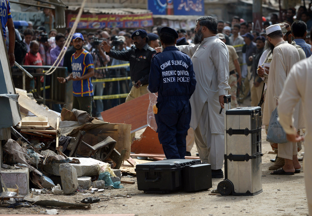 security officials inspecting the site of a bomb attack to collect evidence in karachi on april 24 2014 photo afp