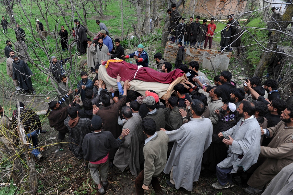 kashmiri muslim villagers carry the body of slain alleged militant shabir ahmmad during his funeral procession in keller some 60 kms from srinagar on april 26 2014 two soldiers and three suspected rebels died in a gunbattle police said soon after the killing of a poll official in india 039 s marathon general elections two of the suspected rebels died late april 25 and the third was killed april 26 when another militant holed up in a house began shooting at government forces as they cleared debris to retrieve the bodies photo afp