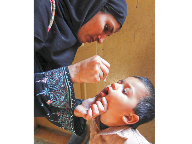 a polio worker administers polio vaccine drops to a boy in karachi where two cases have been registered this year photo file