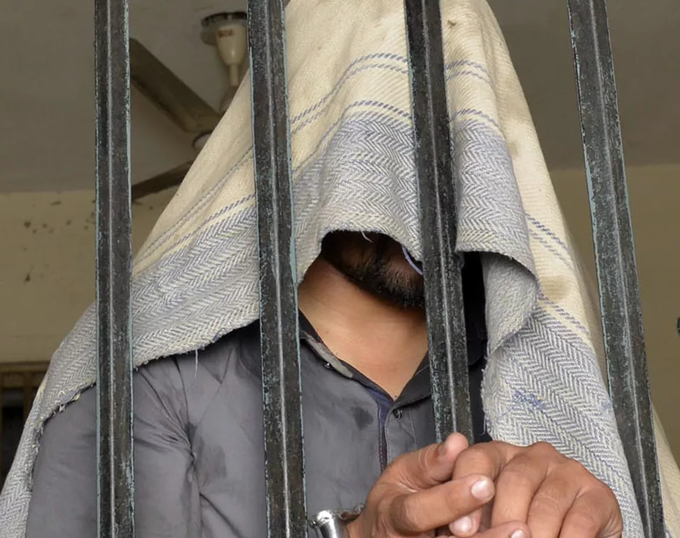 this photo taken on april 27 2014 shows a handcuffed pakistani suspect in connection with the murders of three homosexual men standing in a lockup at a police station in lahore photo afp this photo taken on april 27 2014 shows a handcuffed pakistani suspect in connection with the murders of three homosexual men standing in a lockup at a police station in lahore photo afp