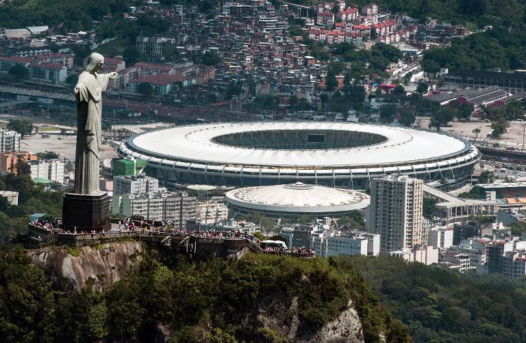 an aerial view of the christ the redeemer statue atop corcovado hill and the mario filho maracana stadium in rio de janeiro brazil on december 3 2013 photo afp