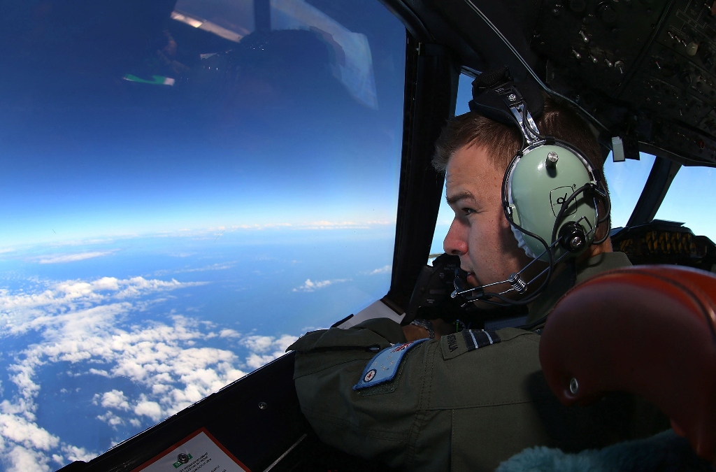 flight lieutenant russell adams looks out from the cockpit of a royal australian air force raaf ap 3c orion aircraft while searching for the missing malaysia airlines flight mh370 over the southern indian ocean march 26 2014 photo reuters