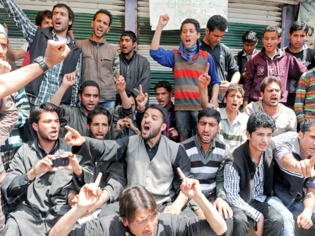 kashmiri muslim youth shout pro freedom and anti election slogans during a protest outside a polling station at kangan in srinagar photo afp