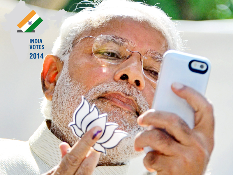 bjp prime ministerial candidate narendra modi takes a selfie after casting his vote at a polling station in ahmedabad photo afp str