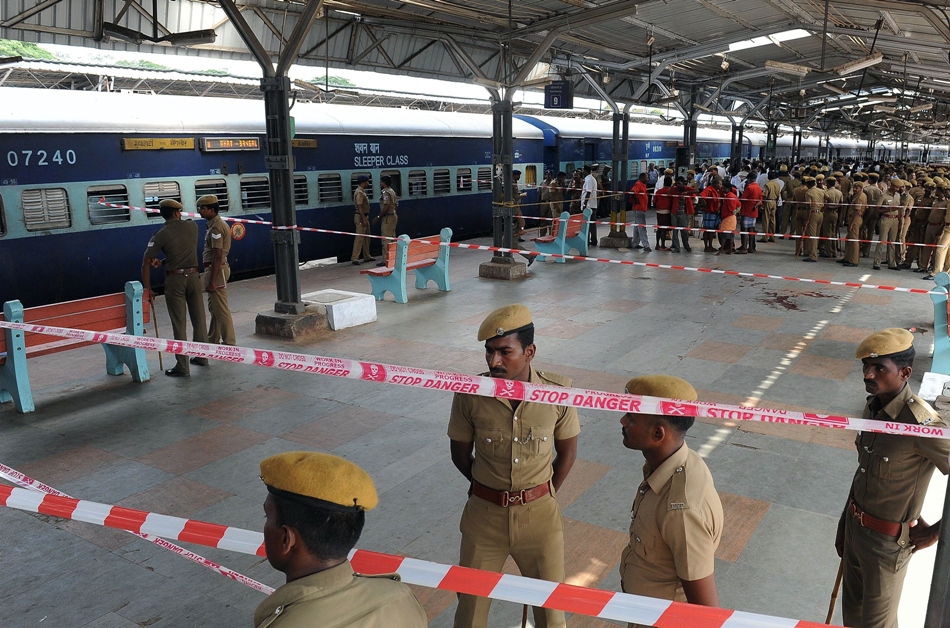 indian police and train station workers stand near the site of a bomb attack at a train station in chennai on may 1 2014 photo afp