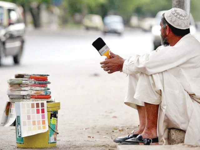 a daily wage labourer sits in wait for employment photo file a daily wage labourer sits in wait for employment photo file