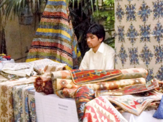 a man selling his crafts at the event photo express a man selling his crafts at the event photo express
