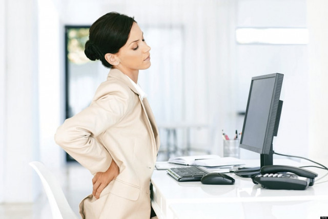 it is particularly common in jobs that are confined to desk work and require long hours of sitting in one position photo file it is particularly common in jobs that are confined to desk work and require long hours of sitting in one position photo file
