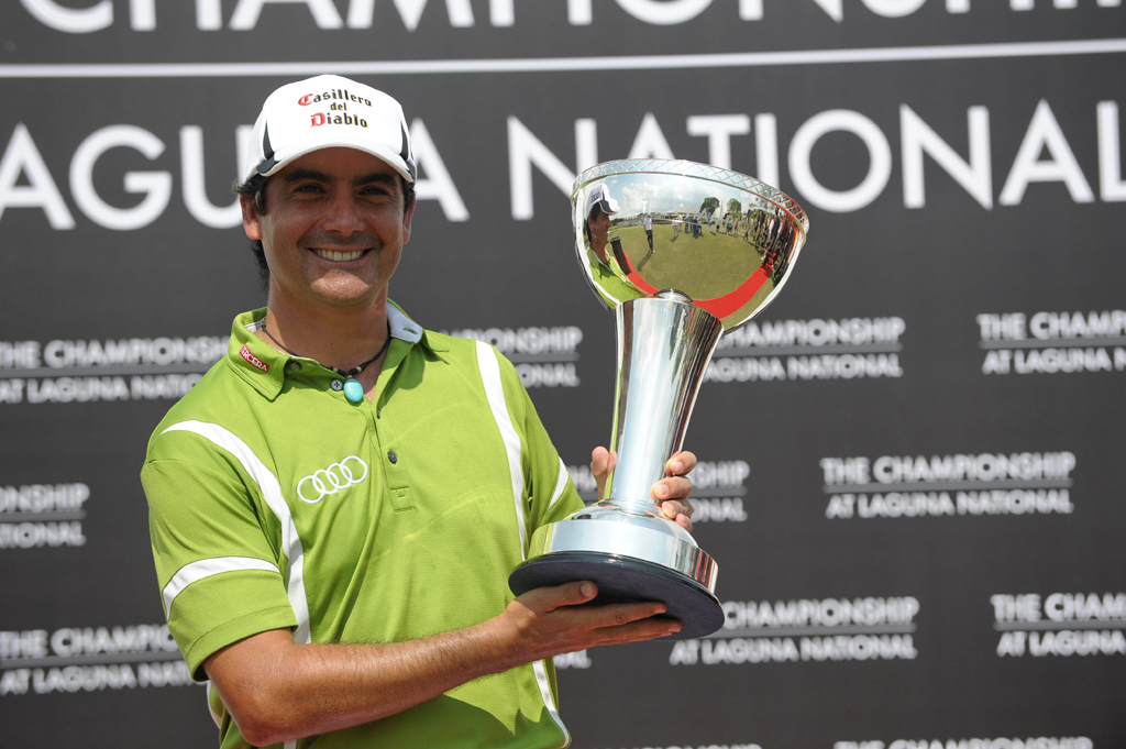 felipe aguilar of chile poses with the trophy after winning of the championship golf tournament at laguna national in singapore on may 4 2014 photo afp